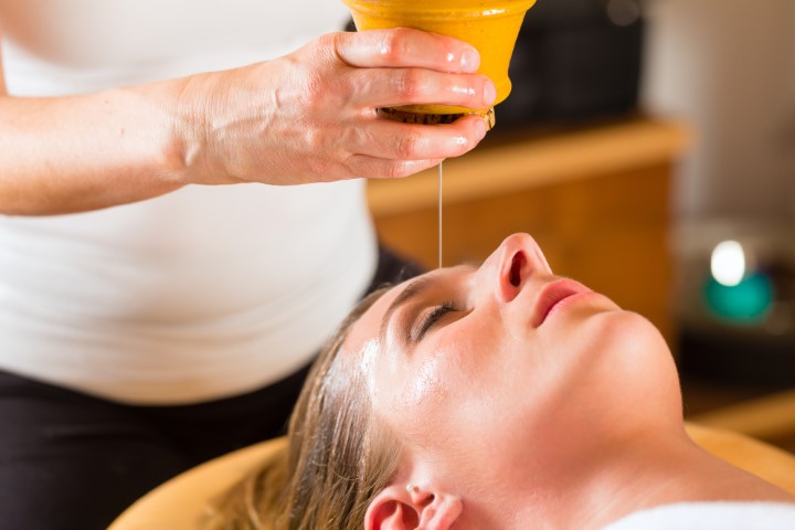 Woman enjoying a Ayurveda oil massage