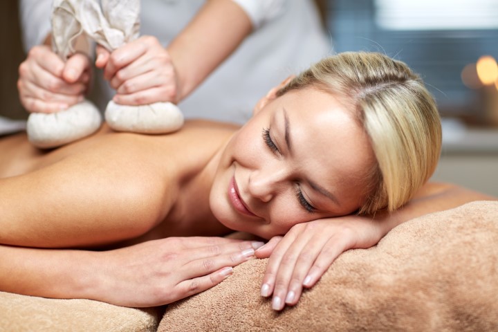 close up of woman lying on massage table in spa